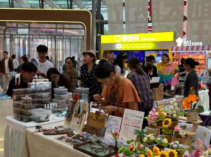 市集现场摊位有序排列顾客穿梭挑选心仪好物氛围轻松愉悦，西安商场摆摊点燃消费新活力 ...